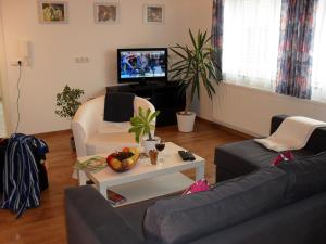 a living room with a couch and a table at Ferienwohnung Ambrosia in Bad Birnbach