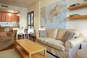 a living room with a couch and a table at Olles Apartment in Barcelona