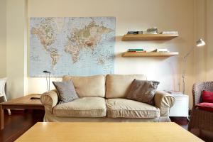 a living room with a couch and a map on the wall at Olles Apartment in Barcelona