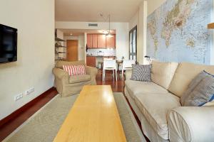 a living room with a couch and a table at Olles Apartment in Barcelona