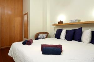 a bedroom with a large white bed with blue pillows at Olles Apartment in Barcelona