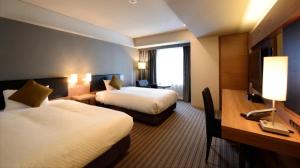 a hotel room with two beds and a desk at HOTEL UNIZO Osaka Yodoyabashi in Osaka +121 photos