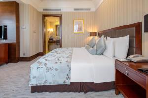 Postel nebo postele na pokoji v ubytování Wuhan Jin Jiang International Hotel