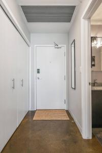 a large white door in a room with a hallway at Downtown Chic Retreat | Elegant + Free Parking in Calgary +35 photos