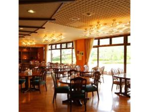 a dining room with tables and chairs and windows at Hotel Silk Onsen Yamabiko in Izushi +41 photos
