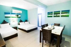 a hotel room with two beds and a table and a desk at Pice Hotel in George Town +87 photos
