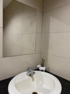 a bathroom with a sink and a mirror at Hotel Perdana in Lawas