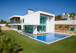 a large white house with a swimming pool at Palmares Beach, Golf & Dream in Lagos