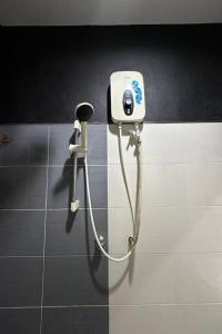 a shower in a bathroom with a hair dryer at Bull & Bear Airport Hotel Langkawi in Kampung Padang Masirat