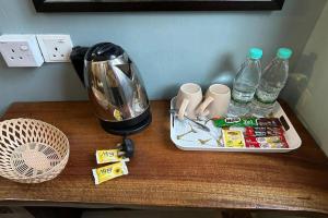 a table with a blender and bottles of water on it at Bull & Bear Airport Hotel Langkawi in Kampung Padang Masirat