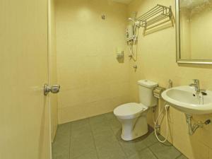 a bathroom with a toilet and a sink at OYO 90669 My Hotel Vistana in Kuala Lumpur +46 photos