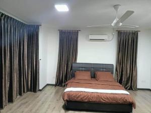 ein Schlafzimmer mit einem Bett in einem Zimmer mit Vorhängen in der Unterkunft OYO HOME 90769 Flo Inn Homestay Bsi in Kampong Parit