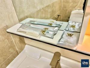 a bathroom with a counter with towels and a sink at Well Hotel by UHA in Johor Bahru +44 photos