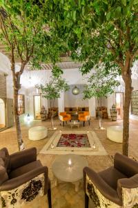 a living room with couches and a table and trees at Riad See Moon And Spa in Marrakech