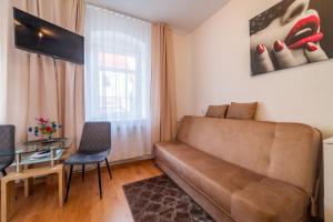 a living room with a couch and a glass table at Pokój od strony ulicy Kajki, Mikołajki in Mikołajki +30 photos