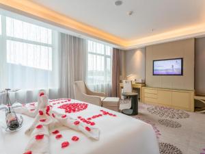 a hotel room with a large bed with red flowers on it at Lavande Hotel Langfang Xianghe in Langfang +57 photos