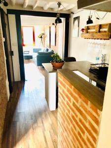 a kitchen and living room with a table and a couch at Casa Torre San Lorenzo in Pisa