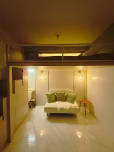 a living room with a couch and a bed at SkyLoft Cebu Casa Mira Guadalupe Aesthetic Japandi Loft with Balcony in Cebu City