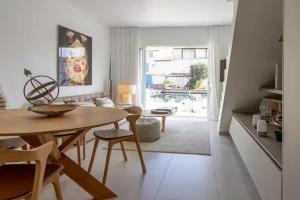 a living room with a table and a dining room at Balandrine in Grimaud