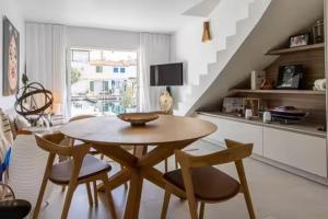 a table and chairs in a living room with a staircase at Balandrine in Grimaud +5 photos