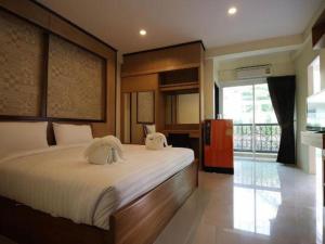 a bedroom with a large bed with two pillows on it at Mon Muang Hotel in Chiang Mai +148 photos