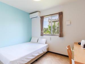Postel nebo postele na pokoji v ubytování Rich Reson ISHIGAKI