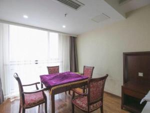 a dining room with a purple table and chairs at GreenTree Inn Sichuan Chengdu Airport Road Express Hotel in Chengdu