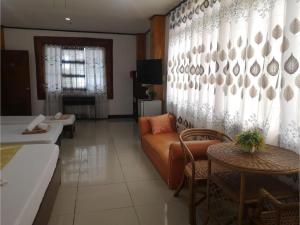a living room with a couch and a table at OYO 880 Flores De Musa Inn in Puerto Princesa City