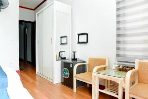 a room with a table and two chairs and a desk at SKY HOTEL - KHÁCH SẠN BẮC NINH in Bắc Ninh