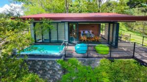 a house with a swimming pool in the backyard at Heliconia Ledge in Mawanella