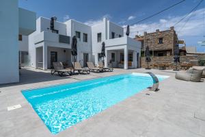 a villa with a swimming pool in front of a house at Kea Paradise in Korissia