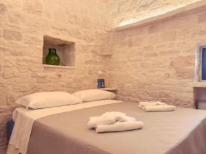 Postel nebo postele na pokoji v ubytování Profumi del Melograno Trulli Resort + 79 fotografií