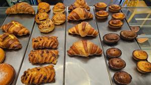 a display case full of croissants and other pastries at Palazzo Emanuele Luxury in Gallipoli