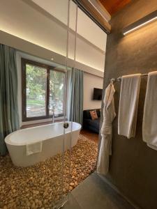 a bathroom with a large tub and a room at Baron's Antiquarian Villa in Cochin
