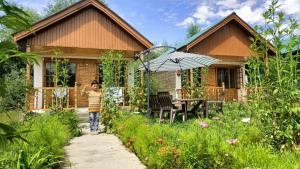 a young boy walking in front of a house at Tololing Eco Resort in Suktiyāl