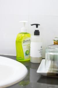 a counter with two bottles of soap and a sink at Elite Home stays by UPAR, Silom in Bangkok