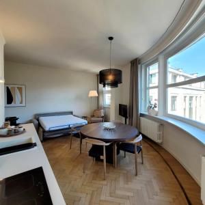 a living room with a table and a couch at Giselda Suite - Oval in Turin