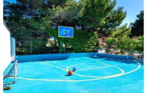 an outdoor basketball court with a basketball hoop at Villa Plenca in Šibenik +33 photos