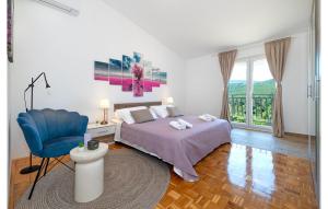 a bedroom with a bed and a blue chair at Villa Plenca in Šibenik
