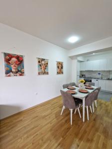 a kitchen and a dining room with a table and chairs at Sunflower City Center with free garage in Skopje