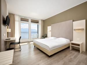 Postel nebo postele na pokoji v ubytování Hôtel Prealpina