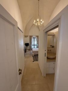 a hallway with a bathroom with a sink and a tub at Dimora Orsini del Balzo in Carovigno +93 photos