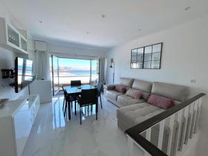 a living room with a couch and a table at housingcoruña BASTIAGUEIRO in Bastiagueiro
