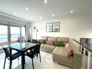 a living room with a couch and a table at housingcoruña BASTIAGUEIRO in Bastiagueiro