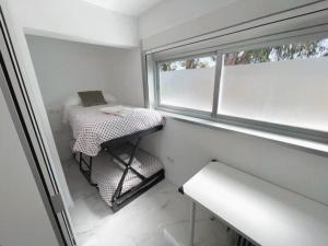 a small room with a bed and a window at housingcoruña BASTIAGUEIRO in Bastiagueiro