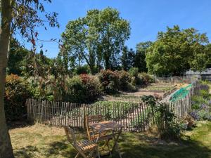a table and chairs in a garden at Chambres d'hôtes chez l'habitant - Bed & Breakfast homestay in Huisnes-sur-Mer