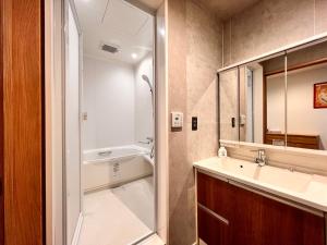 a bathroom with a sink and a shower at Guest House WA in Kyoto