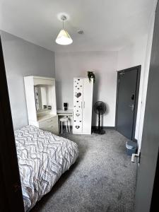 a bedroom with a bed and a desk in it at Private ensuite room close to Rotherham city centre 3 in Rotherham