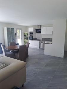 a kitchen and living room with a table and chairs at Villa with pool in Provence in Varages