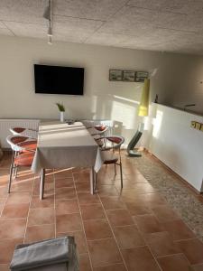 a dining room with a table and chairs and a tv at Lucky 3 Apartments in Løkken